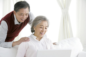 Senior Chinese couple using a laptop