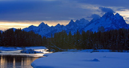 Snake River at twilight below the Grand Teton mountain range peaks in the Central Rocky mountains...