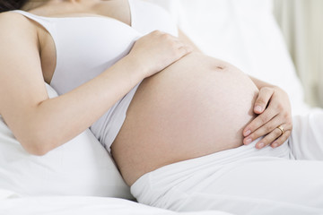 Fototapeta na wymiar Pregnant woman resting in bed