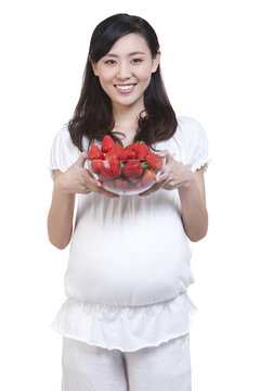 Pregnant woman with fresh strawberries