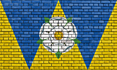 flag of West Yorkshire painted on brick wall