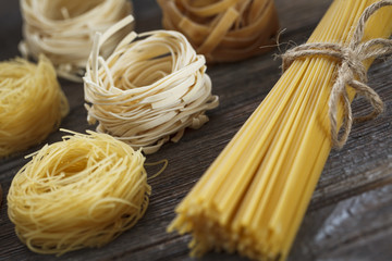 A set of raw pasta on a wooden table