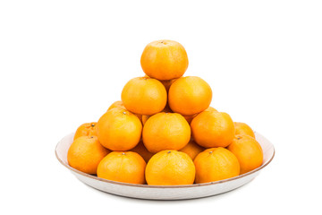 Stack of mandarin oranges in tray with white background
