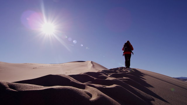 Female climber desert sun sky heat sand shadow hiker