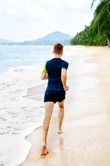 Run. Fit Athletic Man Running On Beach, Male Athlete Runner Jogging On Wet Sand During Outdoor Workout. Athletics. Sports, Fitness And Exercising. Healthy Lifestyle, Wellness And Health Concept