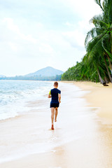 Run. Fit Athletic Man Running On Beach, Male Athlete Runner Jogging On Wet Sand During Outdoor Workout. Athletics. Sports, Fitness And Exercising. Healthy Lifestyle, Wellness And Health Concept