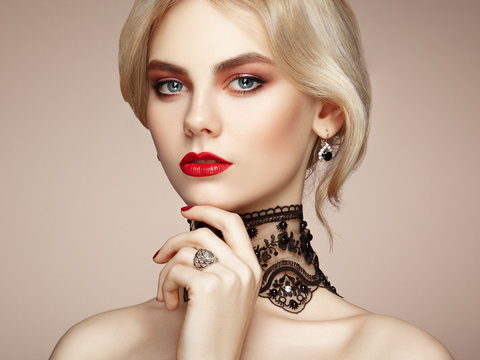 Portrait of beautiful sensual woman with elegant hairstyle.  Perfect makeup. Blonde girl. Fashion photo. Jewelry and lace