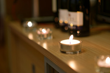 Candles and blurred bottles of wine