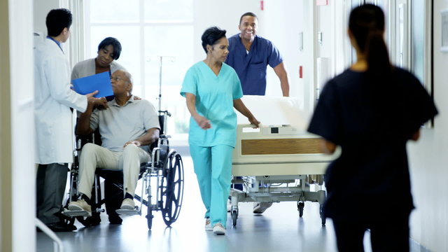 African American disability male on wheelchair and wife in medical center