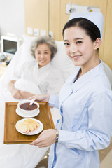 Nurse preparing food for senior patient