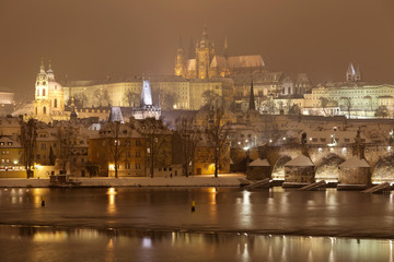 Fototapeta na wymiar Night Prague gothic Castle and St. Nicholas' Cathedral with Charles Bridge, Czech republic