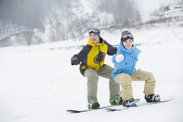 Young couple snowboarding in ski resort