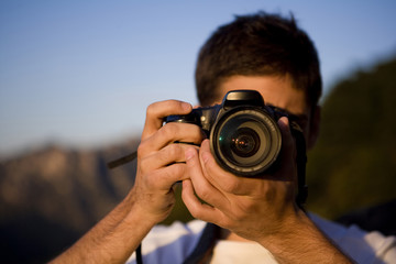 Young man taking a photo at the Great Wall of China