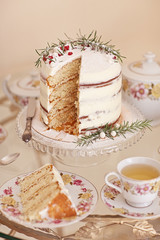 Vintage porcelain tea service with marble winter cake and on glass vintage table. 