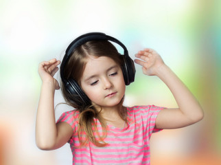 Child girl closed eyes listen music headphones