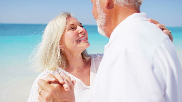 Senior Caucasian couple dancing together on a Caribbean beach