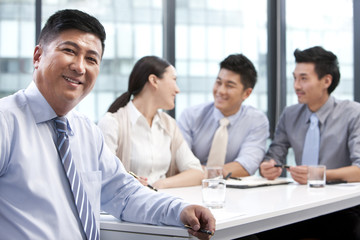 Businessman with colleagues in the background
