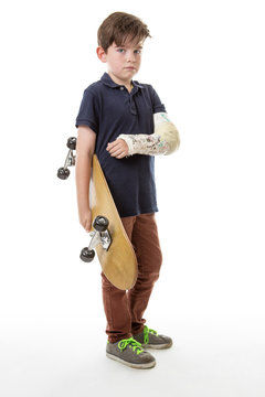 cute young boy holding a skateboard