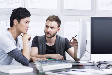 Young adults discussing in office