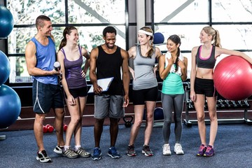 Smiling fitness class posing together 