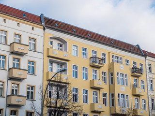 Fototapeta na wymiar Modern Yellow Apartment Building with Balconies