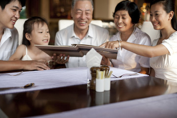 Happy family looking through a menu
