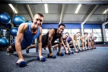 Fototapeta na wymiar Fit people working out in fitness class