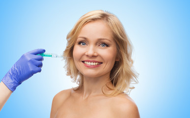 happy woman face and beautician hand with syringe