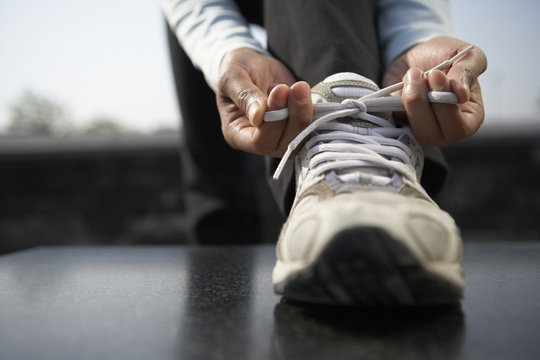 Young Woman Tying Her Shoelaces