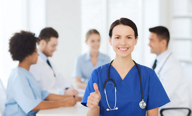 Fototapeta premium happy doctor over group of medics at hospital