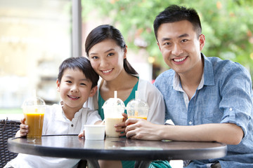 Family enjoying cold drink together