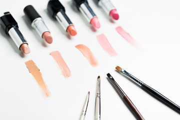 close up of lipsticks range with makeup brushes