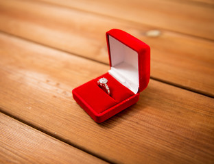 close up of gift box with diamond engagement ring