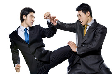 Two businessmen fighting on white background