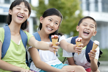 Happy schoolchildren and ice cream cones