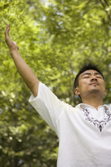 Man Meditating In Park