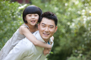 Fototapeta premium Father and daughter having fun in garden