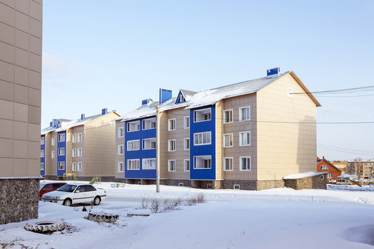 Modern three-storey brick house in a new area of the city