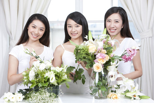 Best female friends arranging flowers together