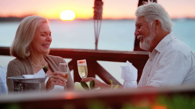 Senior Caucasian couple dining at a tropical resort hotel