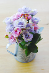 Stock Photo:.Fake hydrangea flowers in zinc watering can on whit