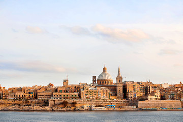 Fototapeta na wymiar Early winter morning in Valletta, Malta. St.Paul cathedral and other landmarks.