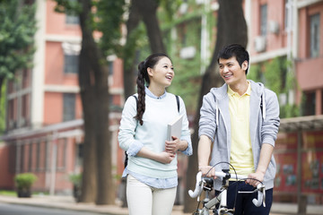 Fototapeta premium Young couple walking on campus