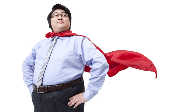 Overweight businessman playing the part of superman