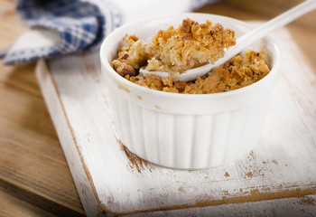 Apple Crumble Dessert on white wooden board.