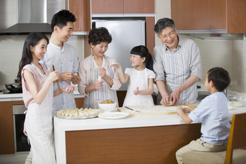Happy family making dumplings