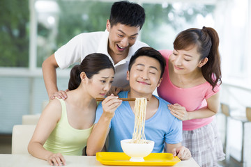 Young man enjoying the smell of noodles