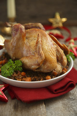 Christmas bird on white plate with bacon and lentils