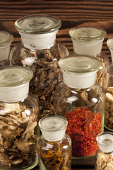 Various Chinese medical herbs in glass bottles