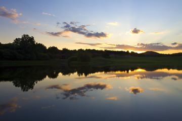 Sun rising over a small lake
